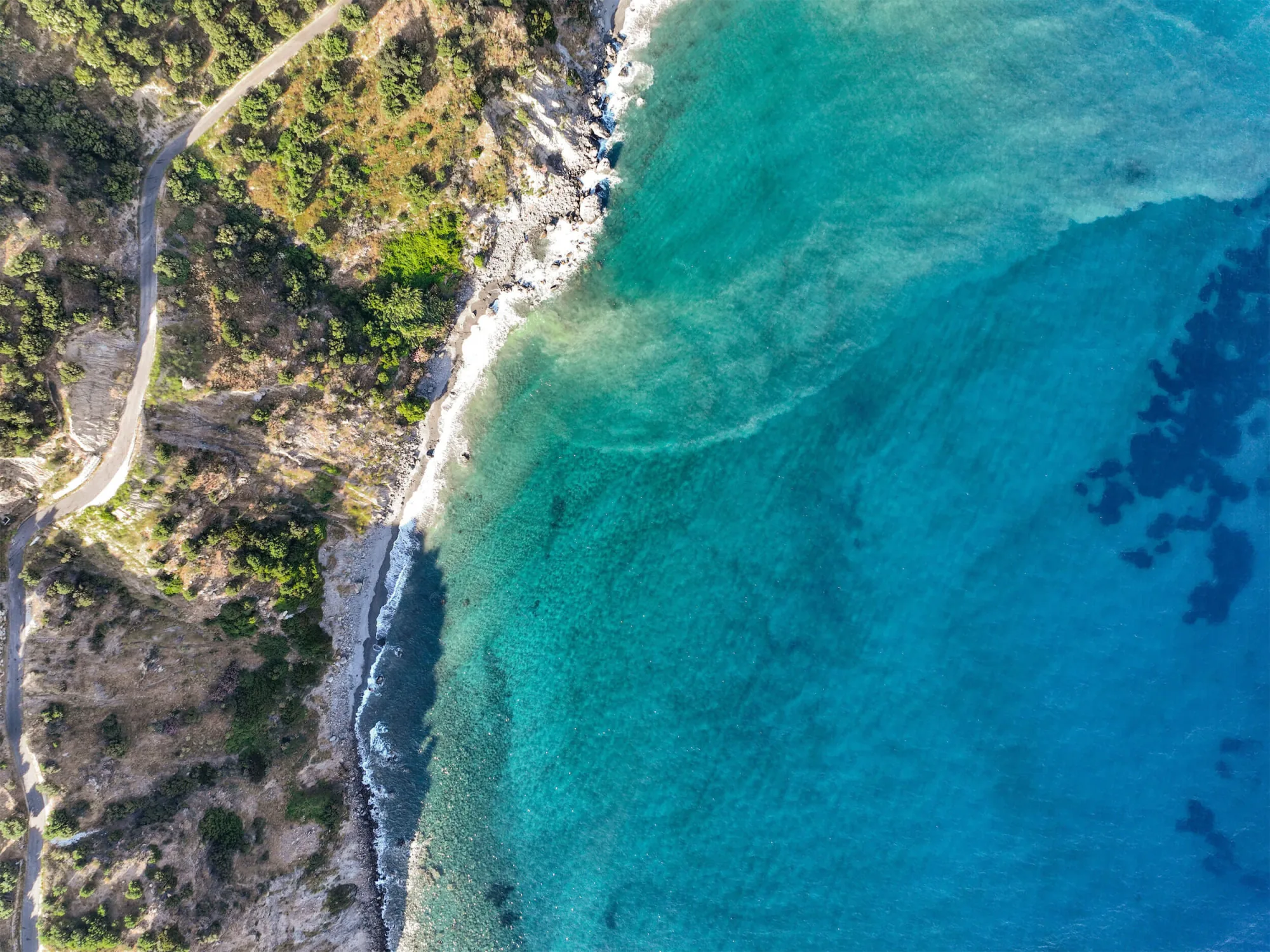 Aerial view of the turquoise coast and a rocky cove near Rodakino, south Crete