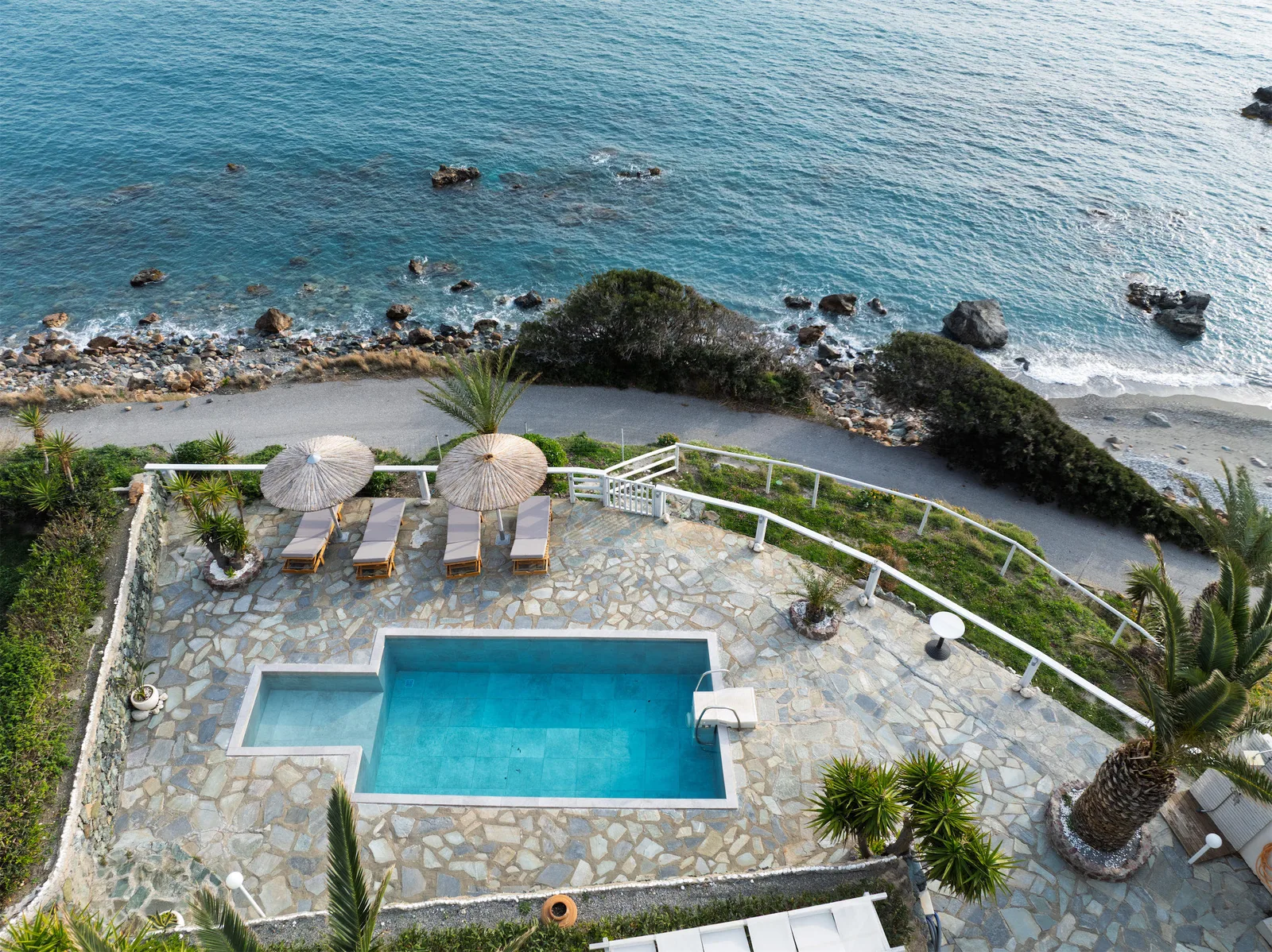Villa Faye — the pool on the flagstone terrace above the shore